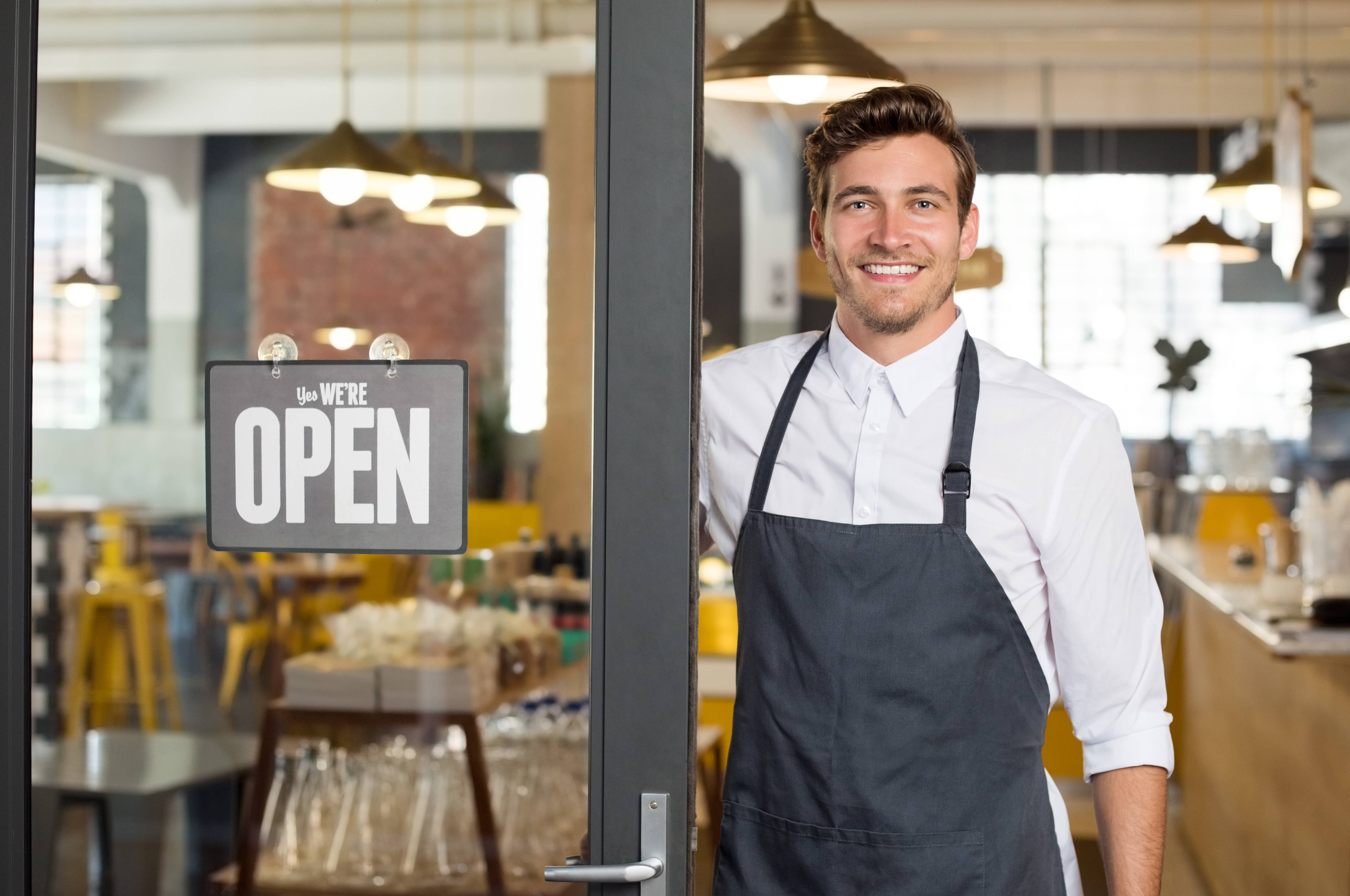 Business owner standing outside front door.