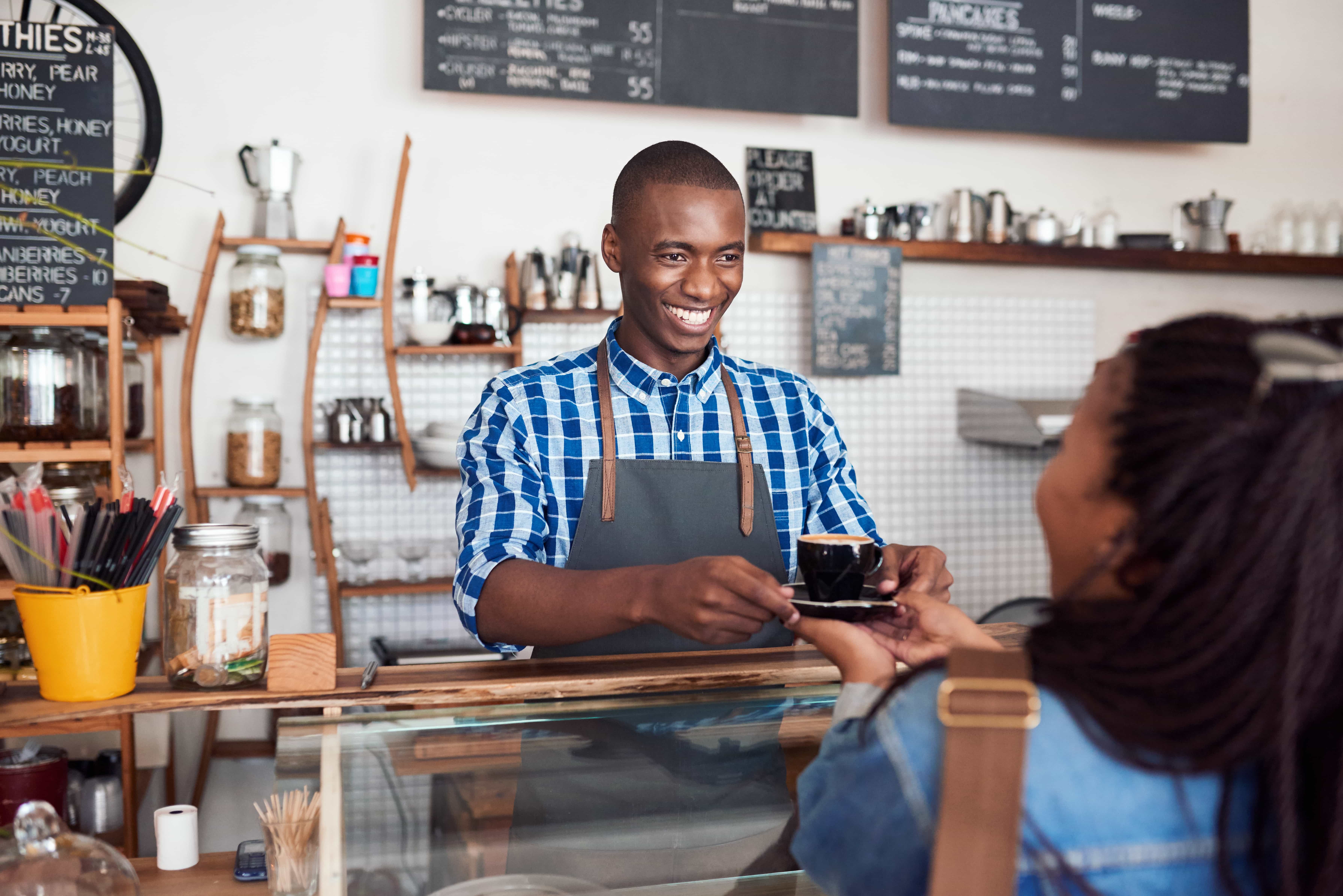 Coffee shop owner serving coffee